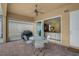 Covered patio featuring brick flooring, a ceiling fan, and access to both the yard and the home at 5662 Fossano Dr, Sarasota, FL 34238