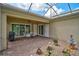 Covered patio featuring brick flooring, a ceiling fan, and access to both the yard and the home at 5662 Fossano Dr, Sarasota, FL 34238