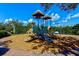 Community playground with slides, climbing structures, and a cushioned ground cover for safety at 5662 Fossano Dr, Sarasota, FL 34238