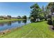Serene backyard featuring a waterfront view, lush greenery, and well-maintained landscaping, creating a peaceful retreat at 5779 Wilena Pl, Sarasota, FL 34238