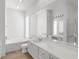 Bathroom featuring tan tile, a large mirror, and a separate bathtub at 5779 Wilena Pl, Sarasota, FL 34238