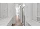 Bright bathroom featuring double vanity with white countertops and glass shower enclosure at 5779 Wilena Pl, Sarasota, FL 34238