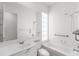 Bright bathroom with combined shower-tub, large mirror, and all white finishes at 5779 Wilena Pl, Sarasota, FL 34238