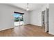 Bedroom features wood floors, neutral paint and a sliding glass door to screened porch at 5779 Wilena Pl, Sarasota, FL 34238