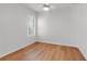 Bedroom features wood floors, a ceiling fan, and window with plantation shutters at 5779 Wilena Pl, Sarasota, FL 34238