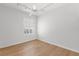 Bedroom features wood floors, a ceiling fan, and plantation shutters at 5779 Wilena Pl, Sarasota, FL 34238