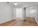 Bedroom features a ceiling fan, wood floors, and mirrored closets at 5779 Wilena Pl, Sarasota, FL 34238