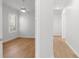 Well-lit bedroom boasts wood floors, a ceiling fan, and a window with plantation shutters at 5779 Wilena Pl, Sarasota, FL 34238