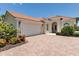 Charming single-story home with red tile roof, well-manicured landscaping, and a two-car garage at 5779 Wilena Pl, Sarasota, FL 34238