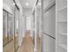 Hallway featuring wood floors, mirrored closets, and built-in shelves at 5779 Wilena Pl, Sarasota, FL 34238