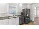 Kitchen with granite countertops, stainless steel appliances, and white cabinetry at 5779 Wilena Pl, Sarasota, FL 34238
