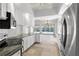 Bright kitchen features granite countertops, white cabinets, and stainless steel appliances at 5779 Wilena Pl, Sarasota, FL 34238