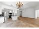 Open kitchen with tile flooring, granite countertops, and adjacent living area at 5779 Wilena Pl, Sarasota, FL 34238
