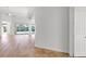 Bright and airy living area with hardwood flooring, leading to an enclosed porch at 5779 Wilena Pl, Sarasota, FL 34238