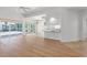 Bright living room featuring hardwood floors and sliding glass doors to the lanai at 5779 Wilena Pl, Sarasota, FL 34238