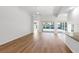 Open floor plan featuring hardwood floors and sliding glass doors to an enclosed porch at 5779 Wilena Pl, Sarasota, FL 34238