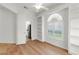 Office with hardwood flooring, built in shelving and a window with plantation shutters at 5779 Wilena Pl, Sarasota, FL 34238