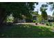 A backyard with a birdbath, patio, landscaping, and mature trees offers a private outdoor space at 616 59Th Nw St, Bradenton, FL 34209