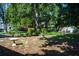 A beautiful backyard with mature trees, landscaping, and a birdbath, offering a serene outdoor retreat at 616 59Th Nw St, Bradenton, FL 34209