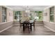 Dining room featuring hardwood floors, and bright windows with views of the backyard at 616 59Th Nw St, Bradenton, FL 34209