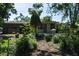 Landscaped yard with mature trees surrounds the home at 616 59Th Nw St, Bradenton, FL 34209