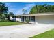 Home featuring a well-maintained lawn, long driveway, and attached two-car garage in a residential neighborhood at 616 59Th Nw St, Bradenton, FL 34209