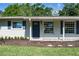 Charming home exterior with tidy front garden, crisp white trim and a cozy front entryway at 616 59Th Nw St, Bradenton, FL 34209