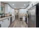 Modern kitchen with stainless steel appliances, white cabinets and hardwood floors at 616 59Th Nw St, Bradenton, FL 34209