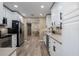 Bright kitchen features stainless steel appliances, white cabinets, and hardwood floors at 616 59Th Nw St, Bradenton, FL 34209