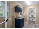 Laundry room with navy cabinets, a utility sink and storage shelves at 616 59Th Nw St, Bradenton, FL 34209