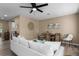 Bright living room with wood-look floors, neutral paint and a comfortable sofa, with a view into the kitchen at 616 59Th Nw St, Bradenton, FL 34209
