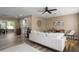 Open living area with wood floors, neutral paint, white sofa, and views into the dining and kitchen areas at 616 59Th Nw St, Bradenton, FL 34209
