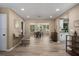 Open-concept living space with wood-look flooring, neutral walls, and seamless flow to dining and kitchen areas at 616 59Th Nw St, Bradenton, FL 34209