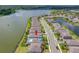 Beautiful aerial view of a lakeside home with a private pool in a well-maintained community at 6550 Devesta Loop, Palmetto, FL 34221