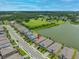 An aerial view of the home shows its location with lake views, green surroundings, and community layout at 6550 Devesta Loop, Palmetto, FL 34221