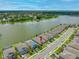 An aerial shot shows the home's location along a lakefront, offering picturesque water views and community layout at 6550 Devesta Loop, Palmetto, FL 34221