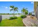 Scenic backyard with a stone patio, lush lawn, and picturesque waterfront views at 6550 Devesta Loop, Palmetto, FL 34221