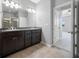 The bathroom features a double sink vanity, a doorway into the bedroom, and a walk-in shower at 6550 Devesta Loop, Palmetto, FL 34221