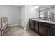 This bathroom boasts a double sink vanity with granite countertops, tile floors, and a soaking tub at 6550 Devesta Loop, Palmetto, FL 34221