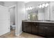 The bathroom features a double sink vanity, a toilet room, and a large glass shower at 6550 Devesta Loop, Palmetto, FL 34221