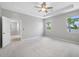 Spacious Primary bedroom boasts tray ceilings, plush carpeting, and stunning views for a luxurious living experience at 6550 Devesta Loop, Palmetto, FL 34221