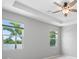 A light, airy bedroom with tray ceilings, views of the lake, and a ceiling fan for added comfort at 6550 Devesta Loop, Palmetto, FL 34221