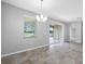A dining area with a window overlooking a lake and a sliding glass door leading to an outdoor space at 6550 Devesta Loop, Palmetto, FL 34221