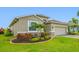 A close up of the exterior reveals meticulous landscaping and decorative stone accents, enhancing the home's curb appeal at 6550 Devesta Loop, Palmetto, FL 34221