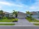 Charming single-story home featuring a well-manicured lawn and attractive paved driveway at 6550 Devesta Loop, Palmetto, FL 34221
