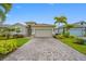 Attractive single-story home with a paved driveway, manicured lawn, and inviting curb appeal at 6550 Devesta Loop, Palmetto, FL 34221