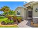 Inviting front entrance with lush landscaping, stone accents, and a stylish front door creating great curb appeal at 6550 Devesta Loop, Palmetto, FL 34221