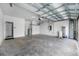 Spacious two-car garage featuring an overhead storage system, utility sink, and water heater at 6550 Devesta Loop, Palmetto, FL 34221
