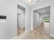 Clean hallway featuring neutral paint, tile flooring, and bright lighting at 6550 Devesta Loop, Palmetto, FL 34221