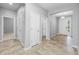 The hallway has tan tiling with access to bedrooms and the front door at 6550 Devesta Loop, Palmetto, FL 34221